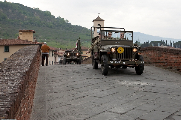 The picture shows the freshly restored Willys of 169th Engineer Combat Battalion crossing the Medici's Bridge in Pontassieve near Florence in 2009.