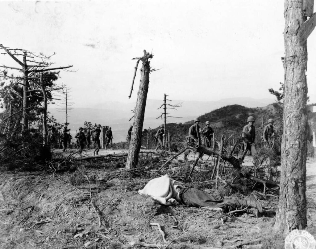 Infantrymen marching over an area in the the Gothic Line smashed by our artillery. North of Ponzalla, Italy. 19 September, 1944. 85th Infantry Division. (Signal Corps.)